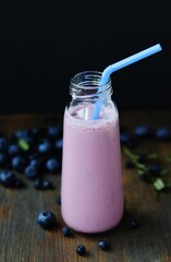 Canvas Print - blueberry yogurt. Milkshake with blueberries in a bottle with a straw. 