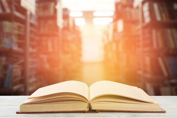 Wall Mural - Open hardcover book on table in library