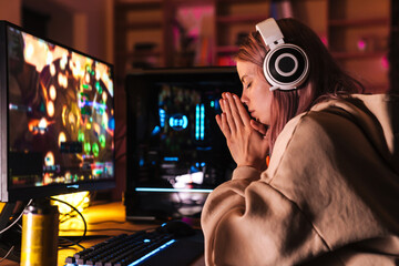 Poster - Image of stressed girl holding palms together while playing video game