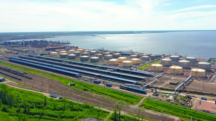 Wall Mural - Panoramic view of the huge transport cargo hub of the seaport on the coast of the sea. Tanks for the storage of flammable liquids