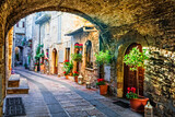 Fototapeta Uliczki - Charming old medieval villages of Italy with typical floral narrow streets. Assisi , Umbria