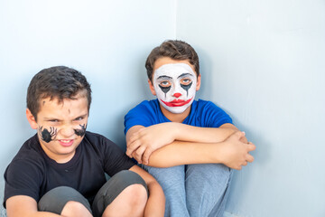 Two brothers sitting in the corner feeling angry