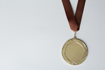 Gold medal on white background, top view. Space for design