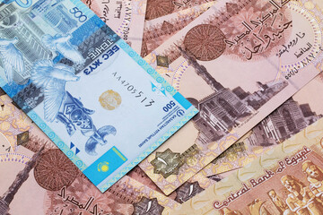 Wall Mural - A blue five hundred tenge note from Kazakhstan with Egyptian one pound bank notes close up in macro