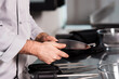 © stockbusters - Chef hands with knife at kitchen restaurant. Closeup hands of male check knife.