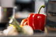 © stockbusters - Fresh vegetables at kitchen restaurant. Closeup red pepper at kitchen table.