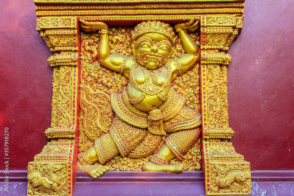 Demon Ritual Building Beautiful golden demon carving in act of carrying the building on the ...