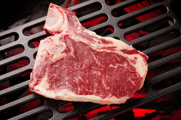 Wall Mural - Raw T-bone beef steak cooking on grill