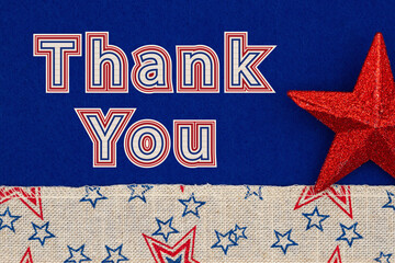 Wall Mural - Thank You type message on blue fabric with a red star