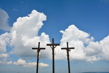 Three Crosses In Front Of White Clouds And  Blue Sky