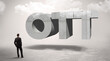 © ra2 studio - Rear view of a businessman standing in front of OTT abbreviation, modern technology concept