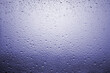 © Amadeu - Drops of rain on a window glass with very diffuse landscape navy blue color