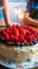 Sparkler Candles On A Birthday Cake Decorated With Fresh Summer Fruits And Berries
