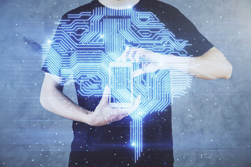 Double exposure of man's hand holding and using a digital device and brain hologram drawing. Data concept.