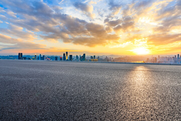 Empty asphalt road and chongqing skyline with buildings at sunset,China.