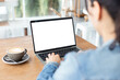 © panitan - computer mockup image blank screen.hand woman work using laptop with white background for advertising,contact business search information on desk at coffee shop.marketing and creative design