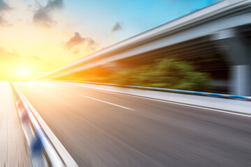 Fast moving asphalt road and bridge background.