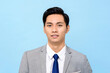 © Atstock Productions - Portrait of  young handsome Asian man in formal business suit isolated on light blue background