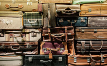 Stack Of Old Assorted Styles Leather And Fabric Luggages