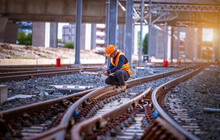Engineer Under Inspection And Checking Construction Process Railway Switch And Checking Work On Railroad Station .Engineer Wearing Safety Uniform And Safety Helmet In Work.