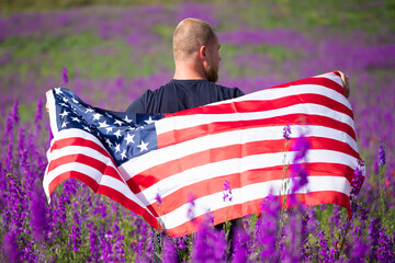  Patriot man holding the american flag on the 4th of July