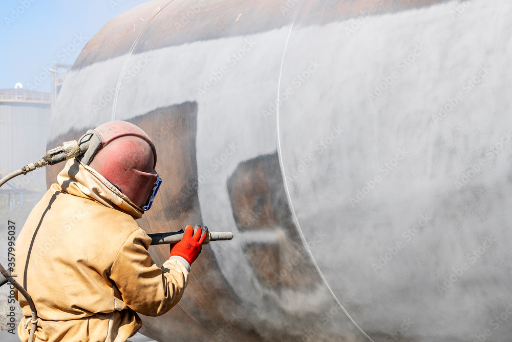 Close up view of sandblasting before coating. Abrasive blasting, more commonly known as sandblasting, is the operation of forcibly propelling a stream of abrasive material against a surface. - obrazy, fototapety, plakaty 