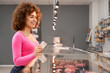 © serhiibobyk - Lady holding card near counter.