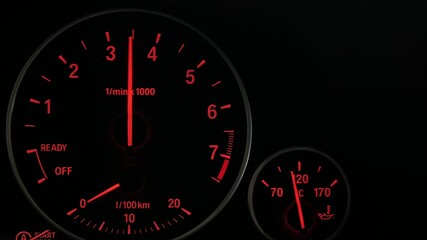 Wall Mural - Close up of sports car dashboard with orange luminous dials. PAN to right.