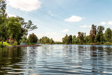 Panoramic View Of Xochimilco Channels Or Canals Along The Floating Gardens Or Chinampas In Mexico City At Sunset