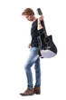 © sharplaninac - Side view of stylish young rocker man carrying guitar on shoulder looking down. Full body length isolated on white background.