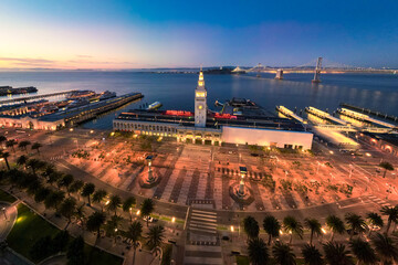 Fototapete - Aerial View of San Francisco Ferry Building and Bay Bridge illuminated at Night