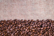 Brown dark roasted coffee beans on old bag background. Photos from the top view and copy space. Seed nature from the above view. Group agriculture grain arabica. Top-down