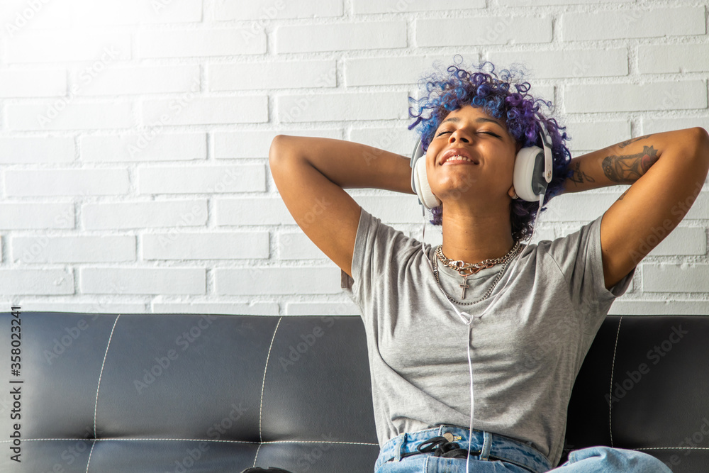 girl or woman at home listening to music with headphones - obrazy, fototapety, plakaty 