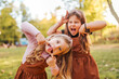 © bnenin - Two little sisters making funny faces outdoors.