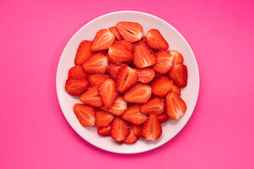 Wall Mural - Round white plate with chopped fresh strawberries