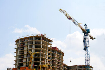 Wall Mural - Modern construction site background. Crane near building.