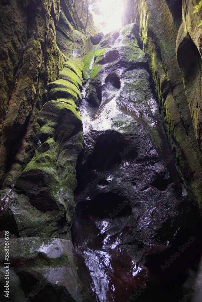 Wet black rocks, former waterfall in a rock niche in The Adršpach ...