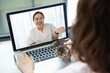 © Chatsiri - Asian women chatting online by making video call on laptop, using videoconferencing app for communication with distance friend, studying online course, virtual learning, close up rear view