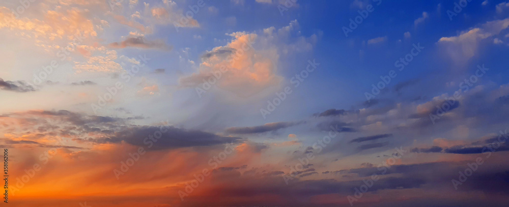 Colorful dramatic sky with big clouds and sunset - obrazy, fototapety, plakaty 