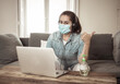 © SB Arts Media - Happy successful young woman on laptop working from home in Coronavirus and New normal concept