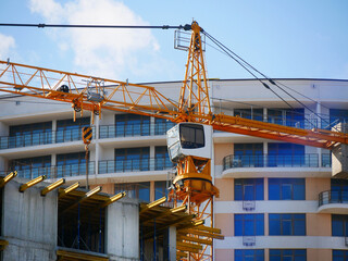 Wall Mural - Crane. Self-erection crane over construction site. Crane near bulding.