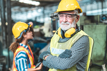 Industrial Engineers in Hard Hats.Work at the Heavy Industry Manufacturing Factory.industrial worker indoors in factory.aged man working in an industrial factory.