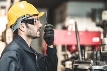 Wall Mural - Industrial Engineers in Hard Hats.Work at the Heavy Industry Manufacturing Factory.industrial worker indoors in factory. man working in an industrial factory.Safety first concept.