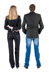 Poster - Back view of business woman and business man in suit.