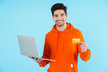 Canvas Print - Happy young bristle man using laptop computer