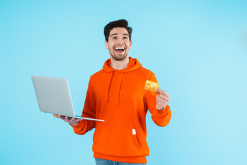 Wall Mural - Surprised young bristle man using laptop computer