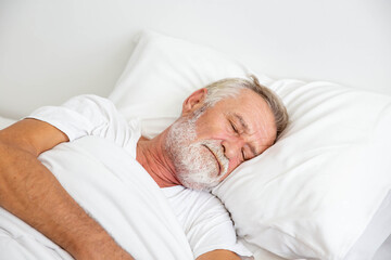 Worried senior retirement man lying awake in his bed