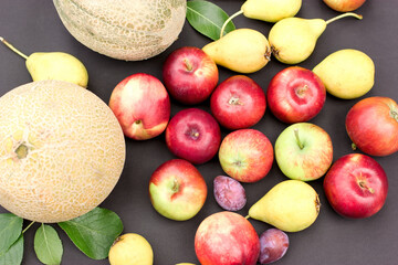 Wall Mural - Fresh organic seasonal fruits on black table 