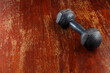 © warongdech - The old dumbbell on a wooden background, with space for text.