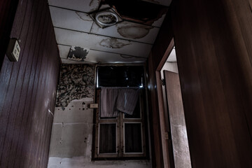 Wall Mural - Bangkok, Thailand - Jan 19, 2020 : Abandoned room with window was left to deteriorate over time, Abandoned house, Destroyed house, Ruined house. Selective focus.